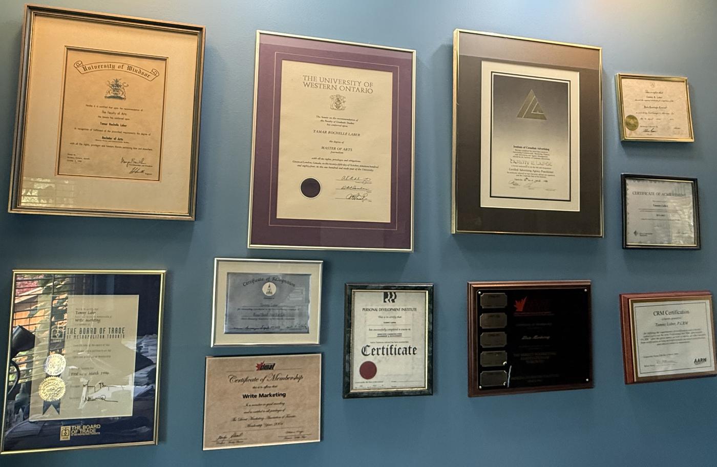 Framed degrees, certificates and awards on the wall of Tammy Laber’s Toronto office